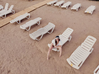 High angle view of young woman lying down on sand