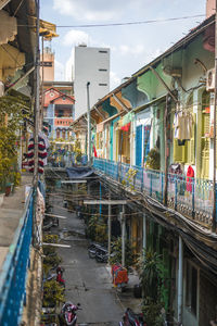 People on street amidst buildings in city