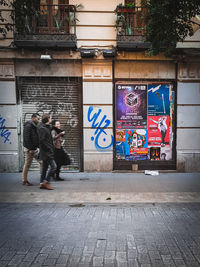 Rear view of people walking on street