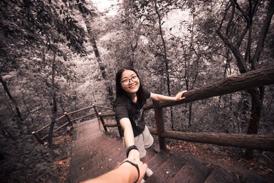 Portrait of young woman in forest