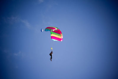 Low angle view of balloons against blue sky