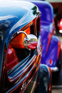 Close-up of chrome side-view mirror on customized car