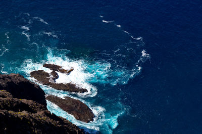 High angle view of rocks in sea