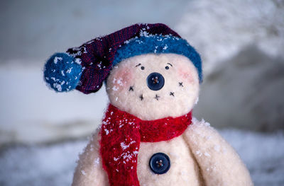 Portrait of a smiling snowman with a button nose and a stocking cap