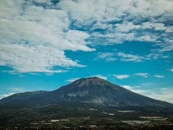 View of volcanic landscape against cloudy sky