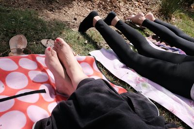 Low section of people relaxing on wood