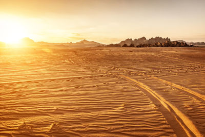 Scenic view of desert against sky during sunset