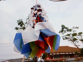 Low angle view of flags against sky