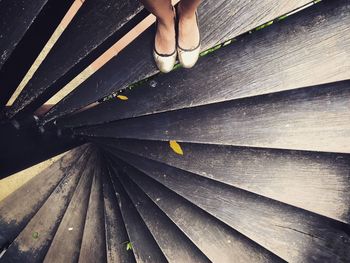 Low section of woman standing on staircase