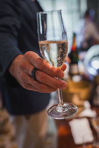 Midsection of man holding wineglass