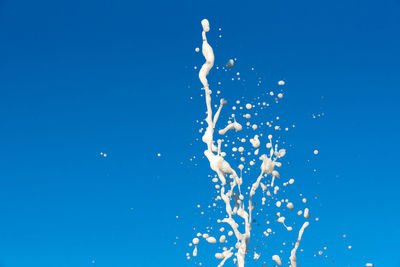 Close-up of splashing water against blue background