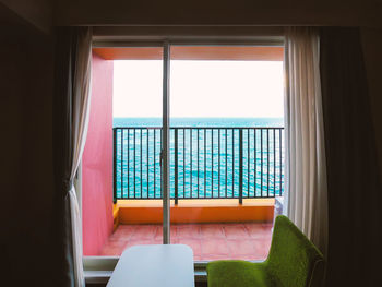 Sea against clear sky seen through window