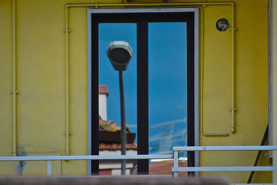 Close-up of metal railing by sea