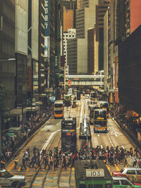 People crossing tramway in city