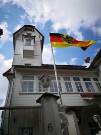 Low angle view of flag against building