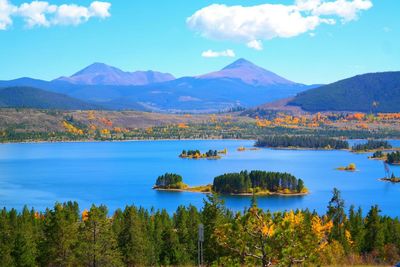 Scenic view of lake and mountains against sky