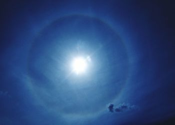 Low angle view of moon in blue sky