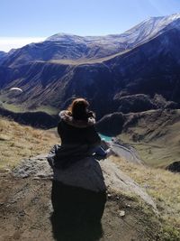 Rear view of man looking at mountain range