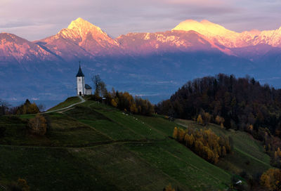 Scenic view of mountain range against cloudy sky