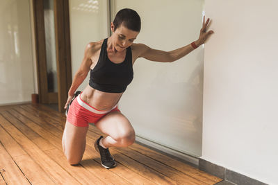 Woman training and stretching outdoors