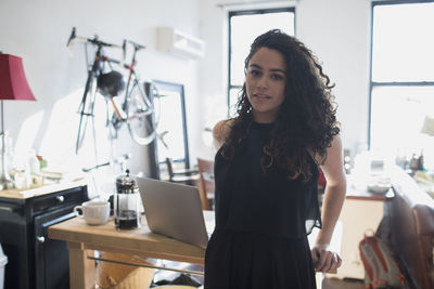 A young woman leaning on a desk