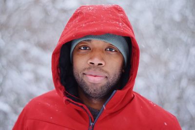 Portrait of young man wearing red warm clothing during winter