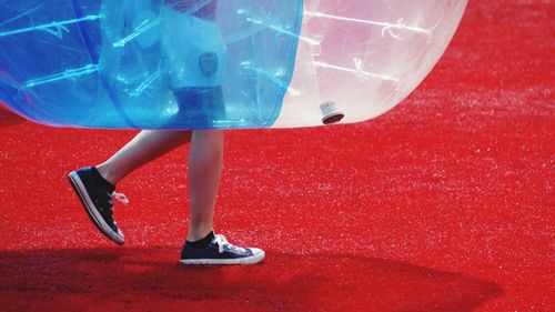 Low section of child playing zorb soccer