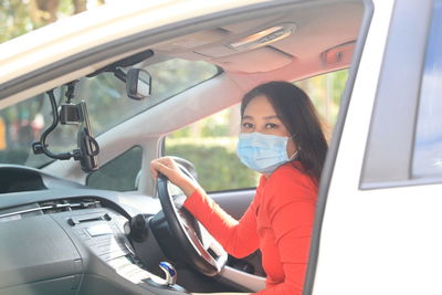 Portrait of woman sitting in car