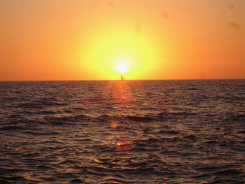 Scenic view of sea against orange sky