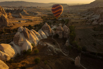 View of hot air balloon flying over landscape