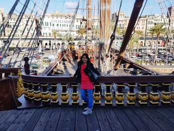 Portrait of woman standing on boats