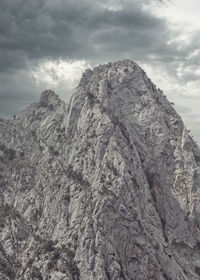 Low angle view of rock formation against sky