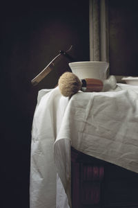 Close-up of shaving equipment on table