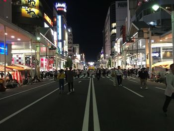 People on city street at night