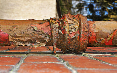 Close-up of rusty pipe attached to wall