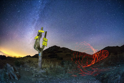 Light painting on field against sky at night