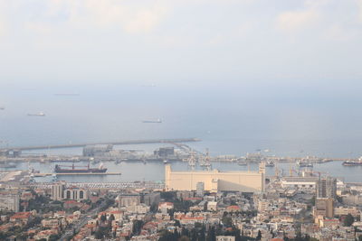 High angle view of buildings by sea against sky