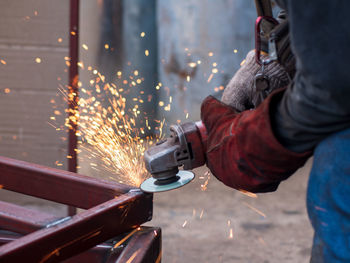 Close-up of worker welding metal