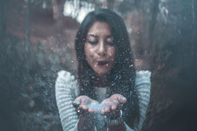 Close-up of woman on wet window in rainy season