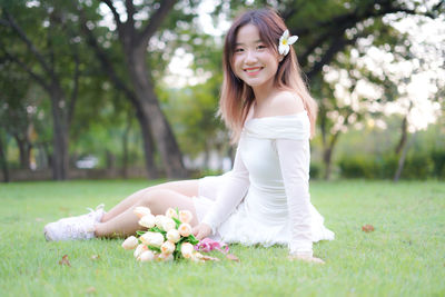 Young woman sitting on field