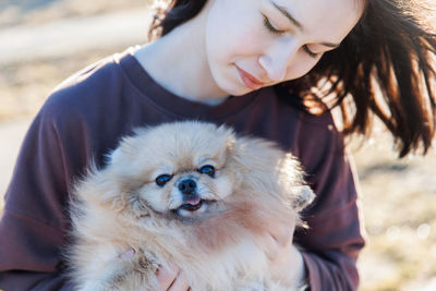 Portrait of woman holding dog