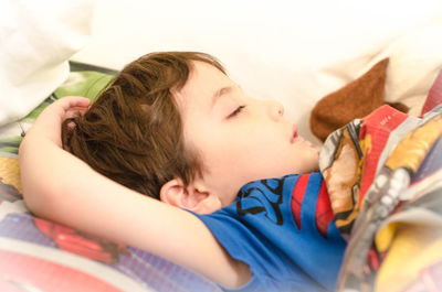 Close-up of boy sleeping on bed