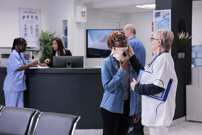 Side view of female friends working in office