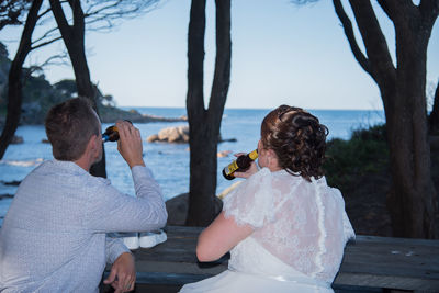 Rear view of couple kissing in sea