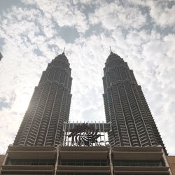 Low angle view of building against cloudy sky