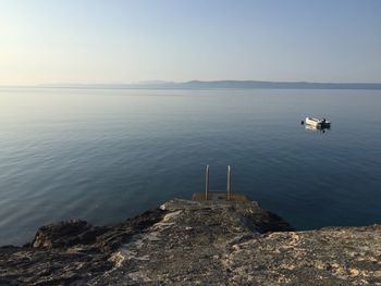 Scenic view of rocks in sea against sky