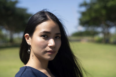 Close-up portrait of beautiful woman in park