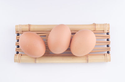 Directly above shot of eggs against white background