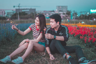 Young woman sitting in park