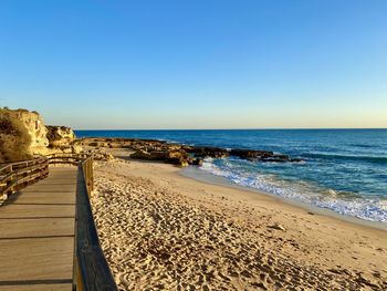 Scenic view of sea against clear blue sky